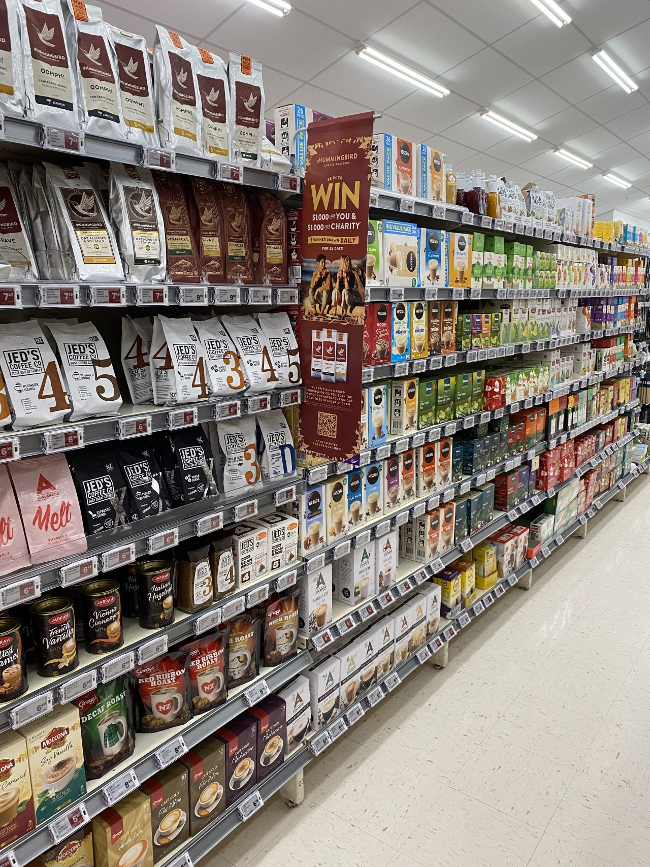 Coffee and hot drink products on shelves in a New World supermarket